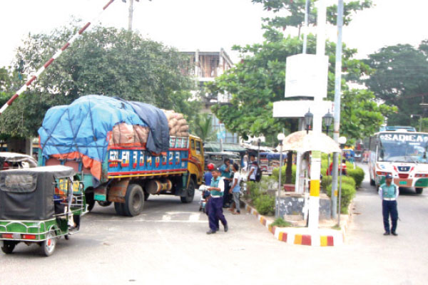 ব্যস্ত নগরীতে দিনের বেলা চলছে ভারী যানবাহন